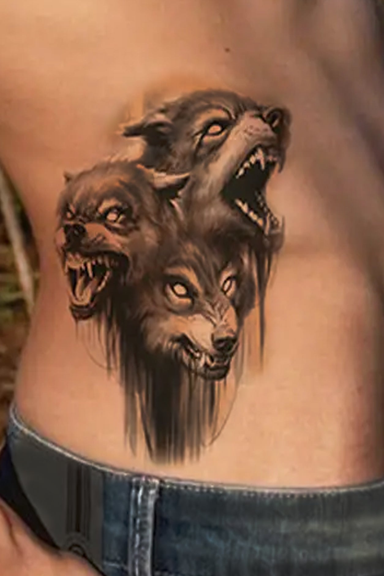 A young person displays a pack of three wolves on there back. A pack of wolves represents loyalty, strong family ties, trust, good communication, understanding, and intelligence.