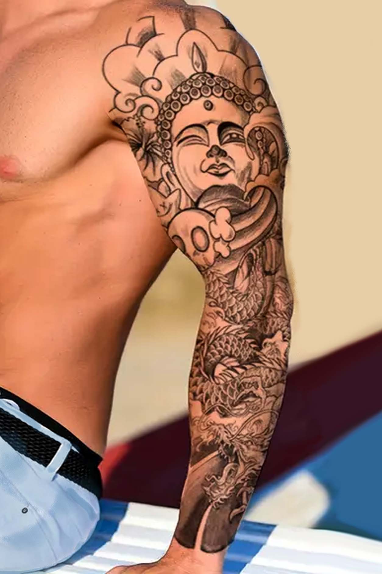 Quan Yin, the beautiful goddess of One Who Sees and Hears the Cry from the Human World. She has a satisfied look as a ray of sunshine warms her. Her trusty dragon coils around, ready for flight. The background is filled with Quan Yin’s headdress and wavy clouds. Her dragon is the Chinese translation of the serpentine Naga, a powerful, often destructive beast that twists and turns, symbolizing impermanence. This full sleeve of artwork will grace an arm from writ to shoulder.