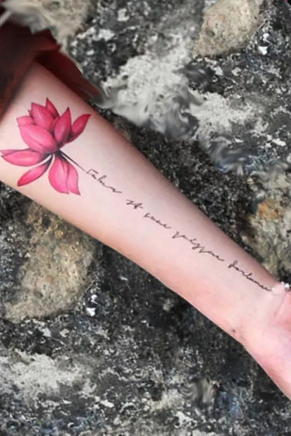 A neutral-gender arm displays the bright red-pink lotus rose with the text "Flower of love, purity, and strength" in an artistic scroll for the stem. 