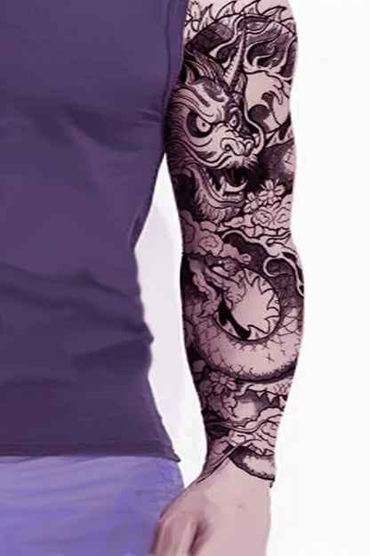 A guy in a purple shirt displays the full sleeve dragon tattoo.