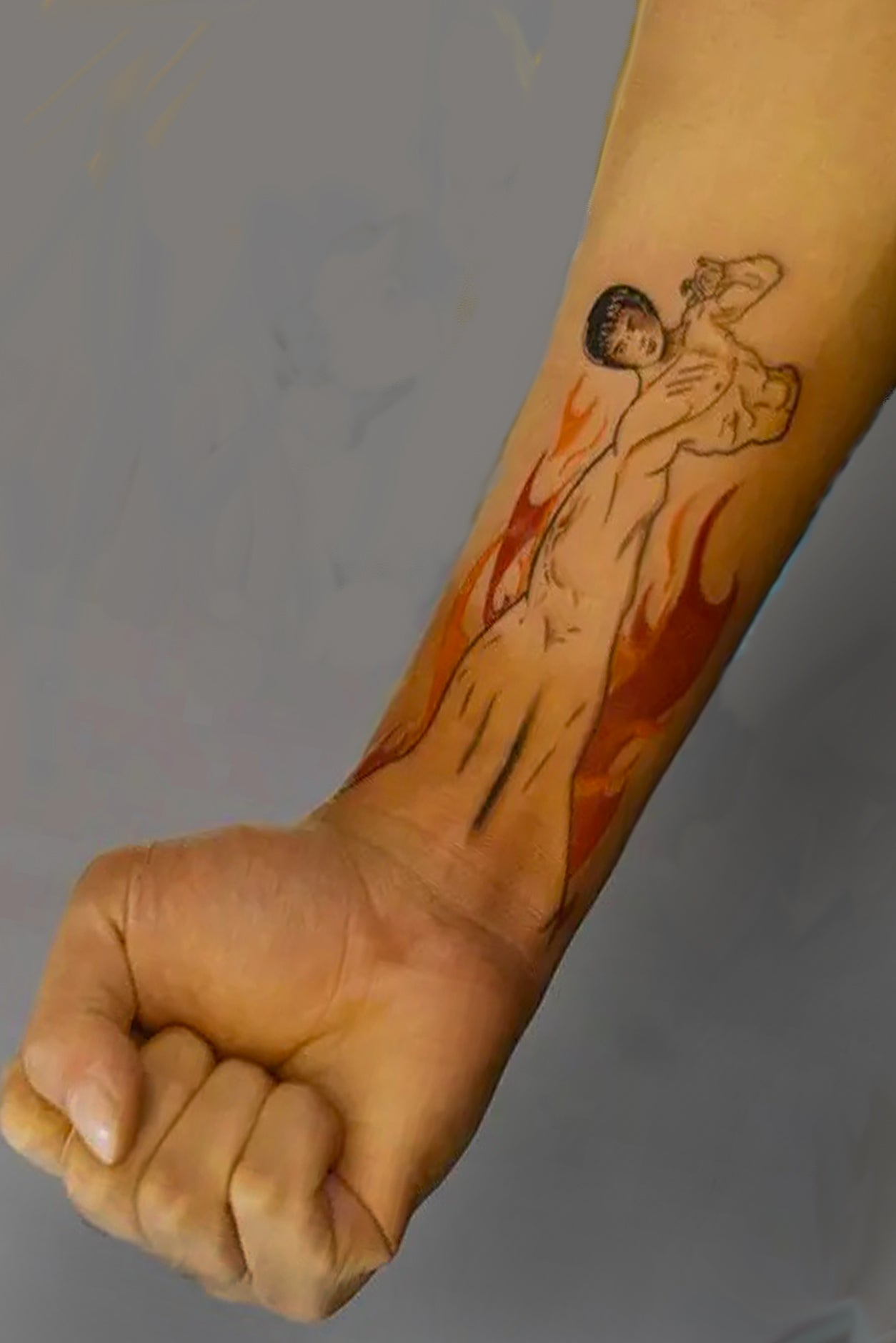A male arm displays the temporary artwork. There is only one way to wear this tag, and the suggested placement is at the lower portion of your arm so that your fist finishes the martial art person's punch..