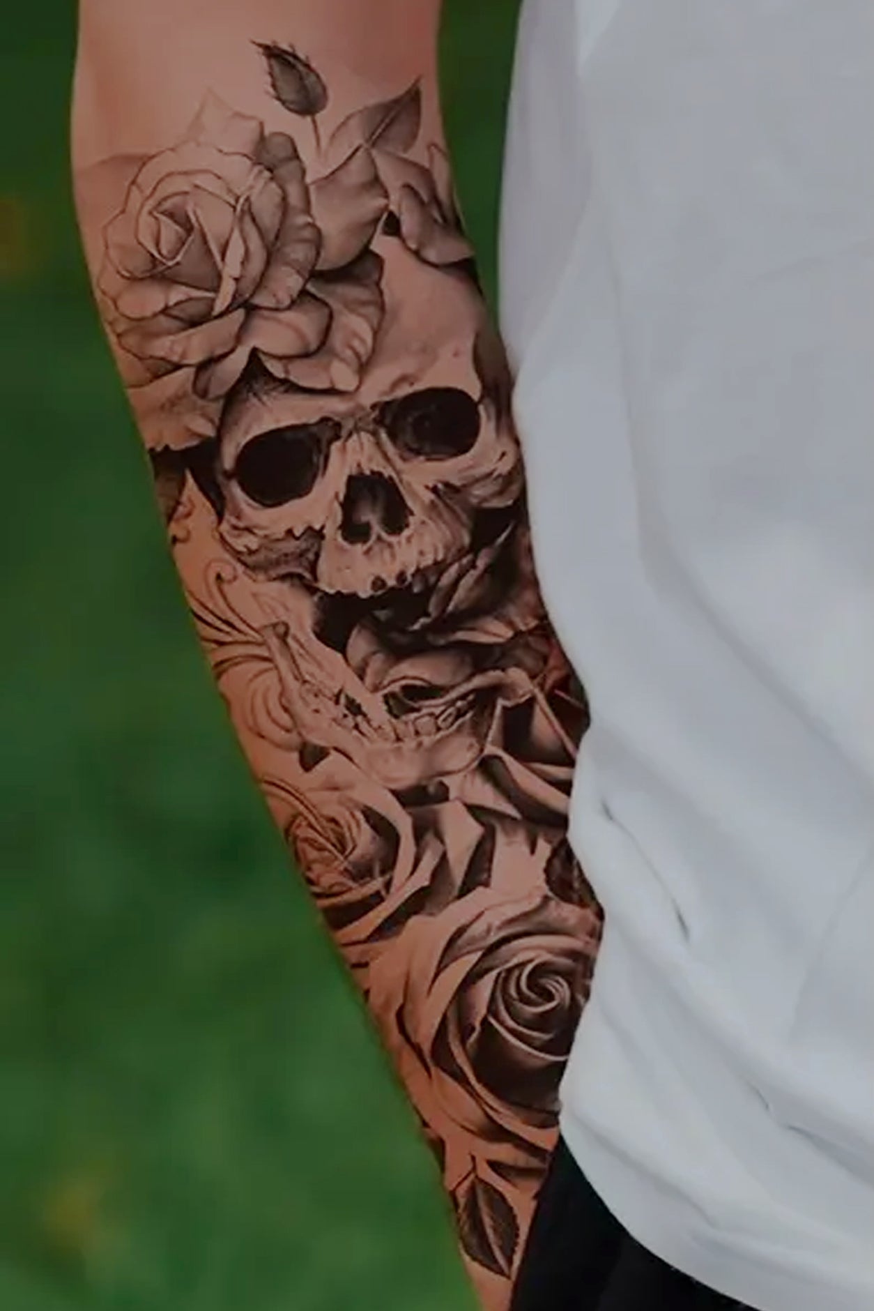 A gender-neutral arm displays the skull and roses tattoo. The skull’s former owner celebrates his life with roses, the ultimate symbol of spirituality, purity, and innocence, a perfect tat for an arm or any body part. The art is tradtional black ink.
