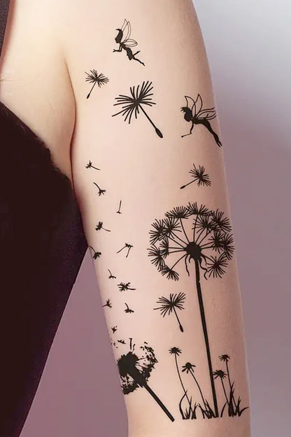 This is an image of the fairies and dandelion tattoo attached to a womans arm.