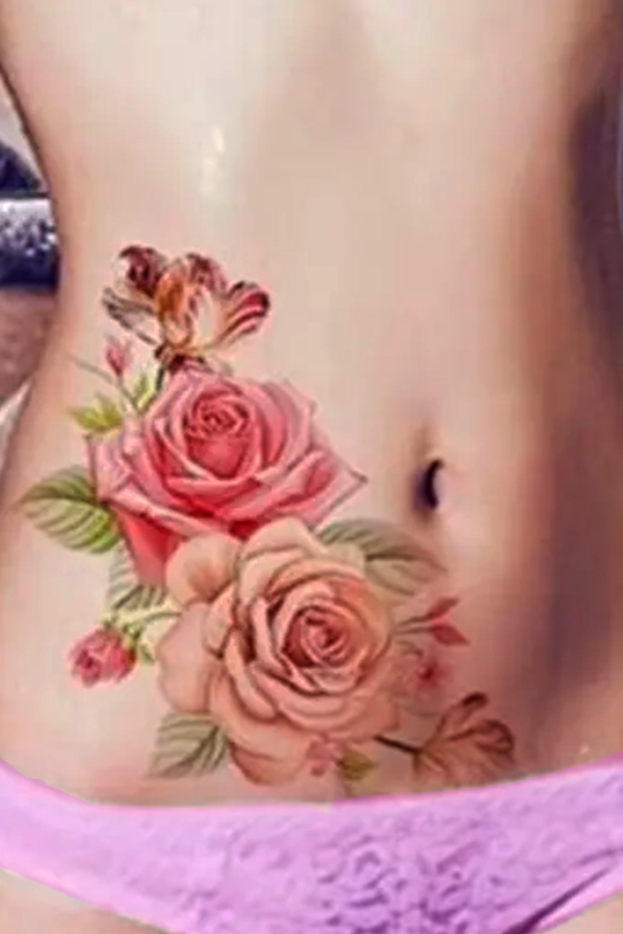 A girl displays her torso with roses. A delicate bouquet of lifelike pink and deep pink roses will beautify your arm, leg, torso, hip, or chest. The delicate rose capture light and shadow just right, the spray has tiny buds and leaves in the background at the right juxtaposition.